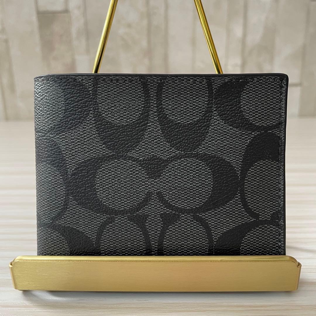訳あり新品 COACH 二つ折り財布 シグネチャー柄 ブラック