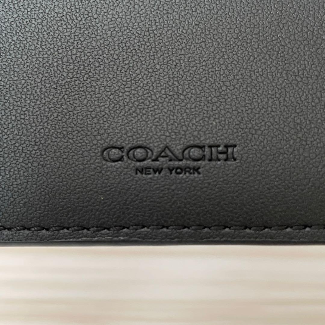 訳あり新品 COACH 二つ折り財布 シグネチャー柄 ブラック