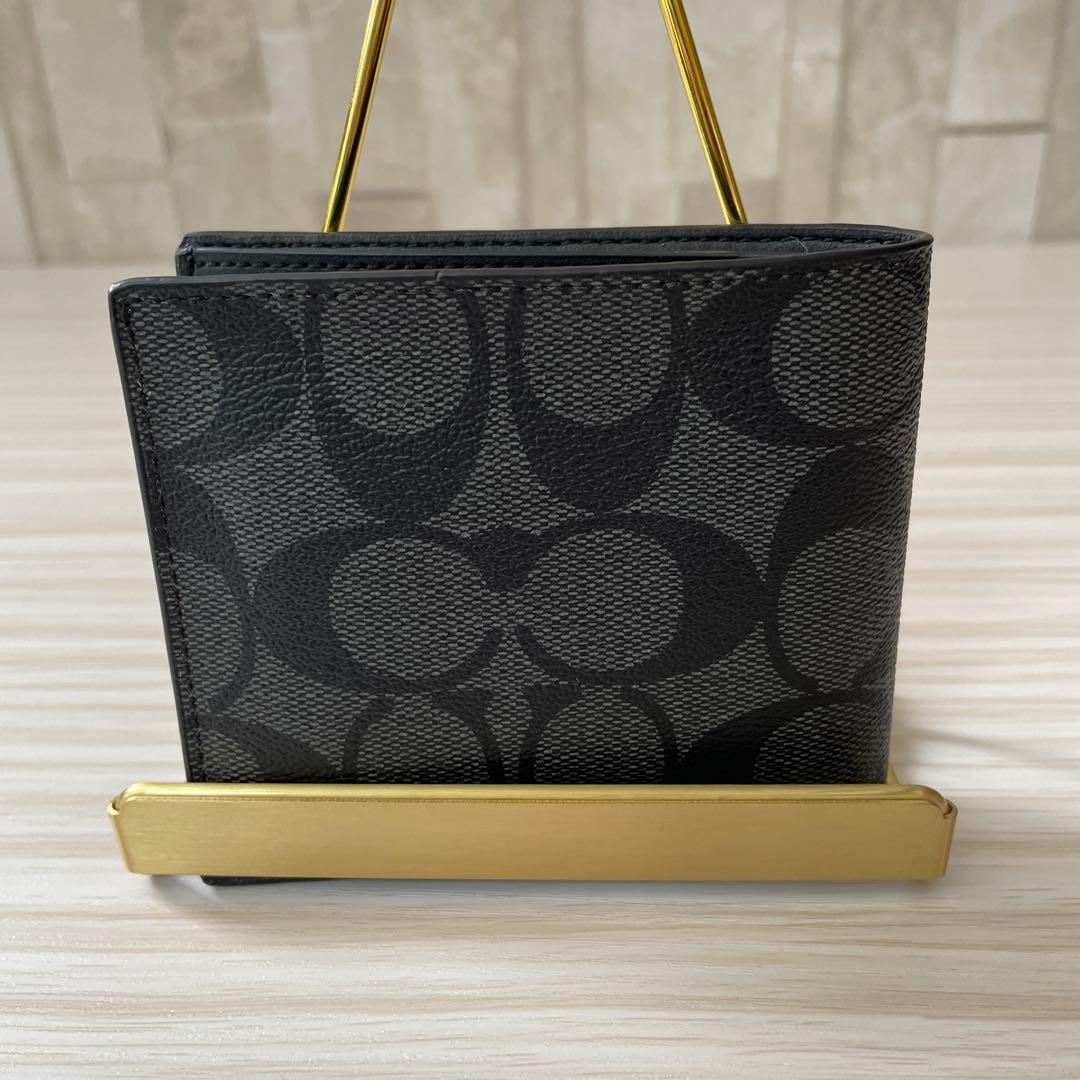 訳あり新品 COACH 二つ折り財布 シグネチャー柄 ブラック