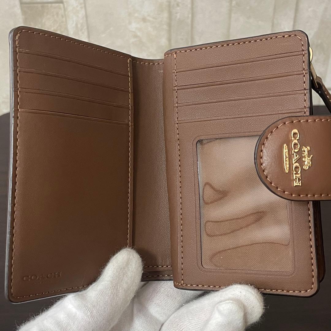 訳あり新品 COACH 二つ折り財布 シグネチャー総柄 ブラウン